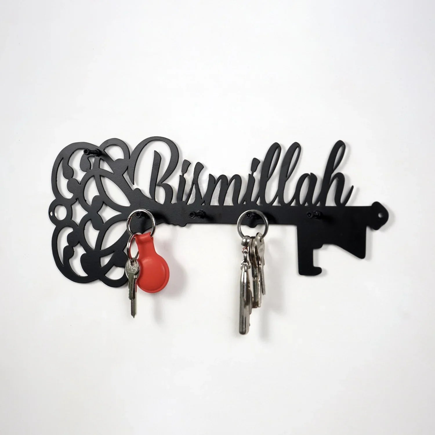 Black metal key holder with 'Bismillah' calligraphy wall art and hanging keys