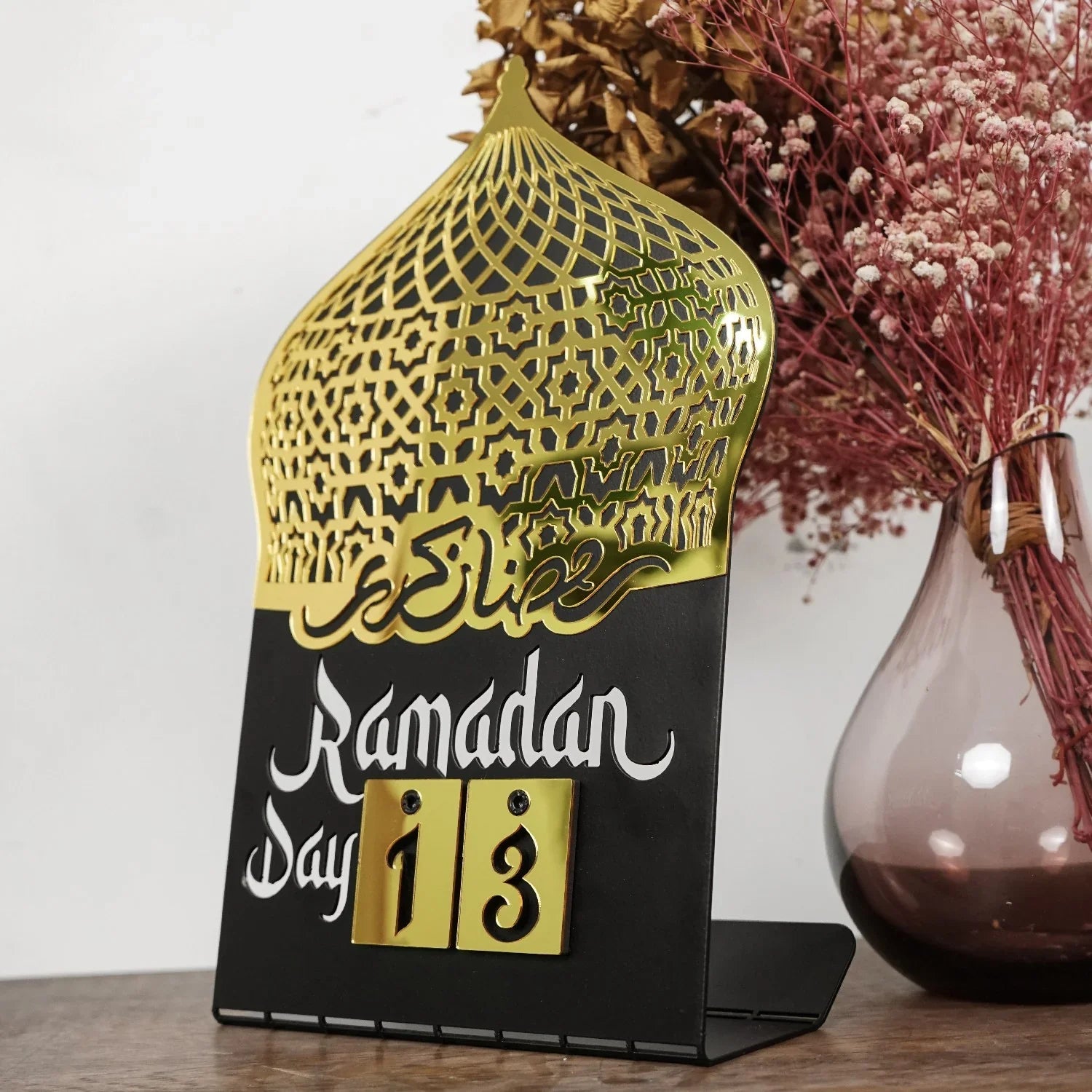 Gold and black Ramadan day countdown tabletop decor with Islamic geometric pattern
